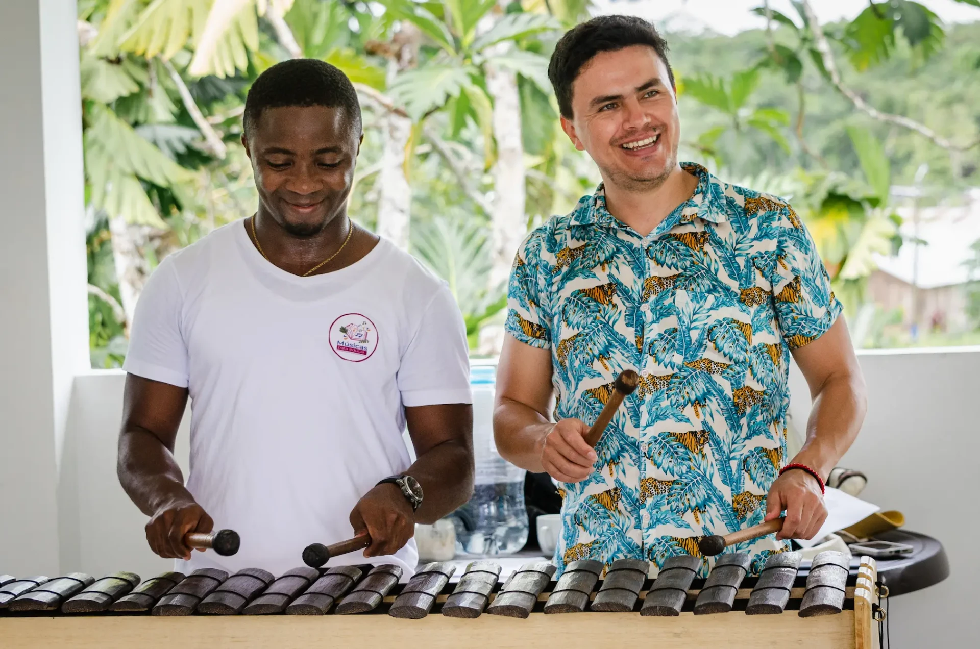 Traveller playing the marimba with a master musician in Guapi