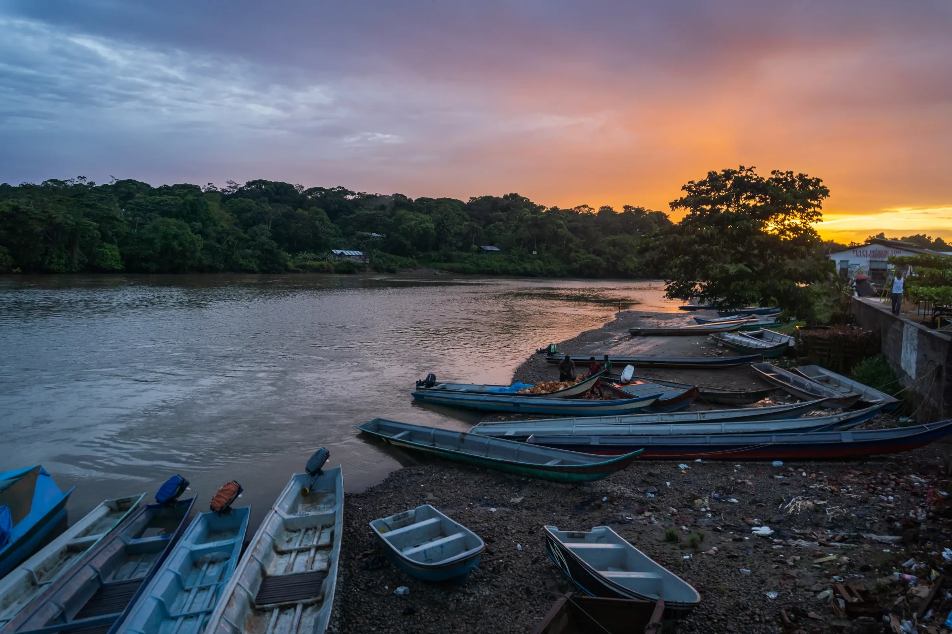 Sunset over the Guapi river with potrillo canoes moored on the bank